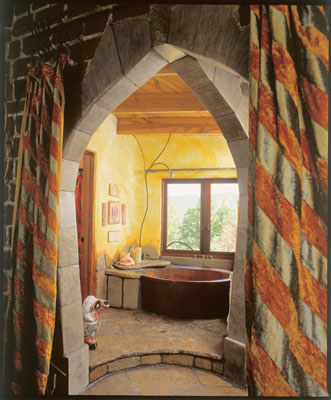 The master bathroom's recycled-copper tub has a soothing mountain view.